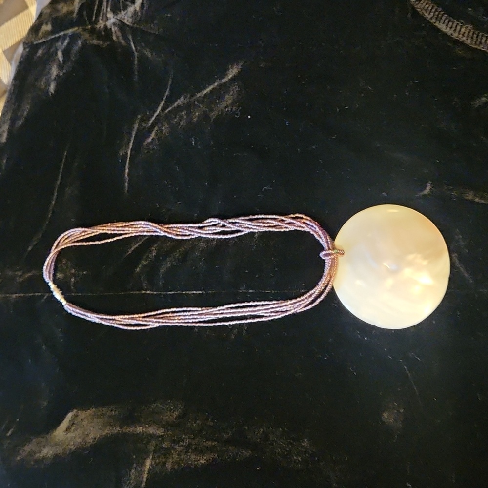 Multi-strand beaded statement necklace with iridescent shell accent